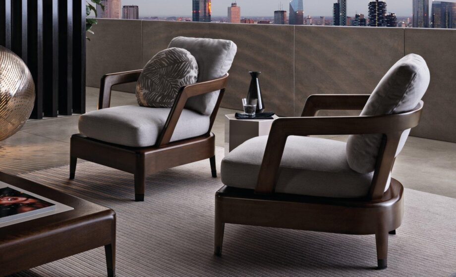 Virginia Outdoor outdoor armchair | Minotti. Elegant outdoor armchair, offering comfort with plush cushions and durability with a solid Iroko frame; well-suited for both small spaces and hospitality needs.