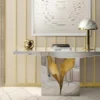 Lapiaz console | Boca Do Lobo. This modern console features an exquisite stone-like crack design with a luxurious polished brass interior, bringing elegance and a unique aesthetic to any space.