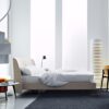 Edel bed | Lema. Dreamy vintage bed with curved headboard, enveloping padding, and velvet details. Custom fabric options available. Luxurious sleep experience.