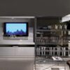 Johns Hi-fi tv furniture | Minotti. Multimedia cabinet with dedicated spaces for organized storage, cable management system, and sleek sliding doors for a clutter-free, stylish entertainment area.