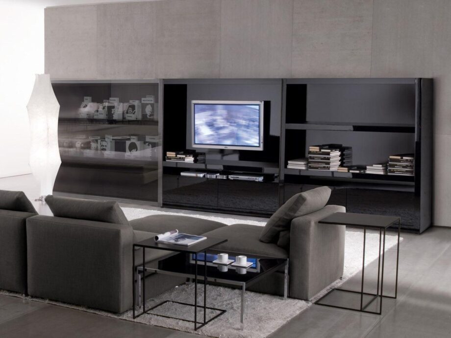 Johns Hi-fi tv furniture | Minotti. Multimedia cabinet with dedicated spaces for organized storage, cable management system, and sleek sliding doors for a clutter-free, stylish entertainment area.