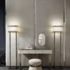 Gordon floor lamp | DV home. Elegant floor lamp with a metal structure and fabric shade, embodying luxurious Art Deco design.