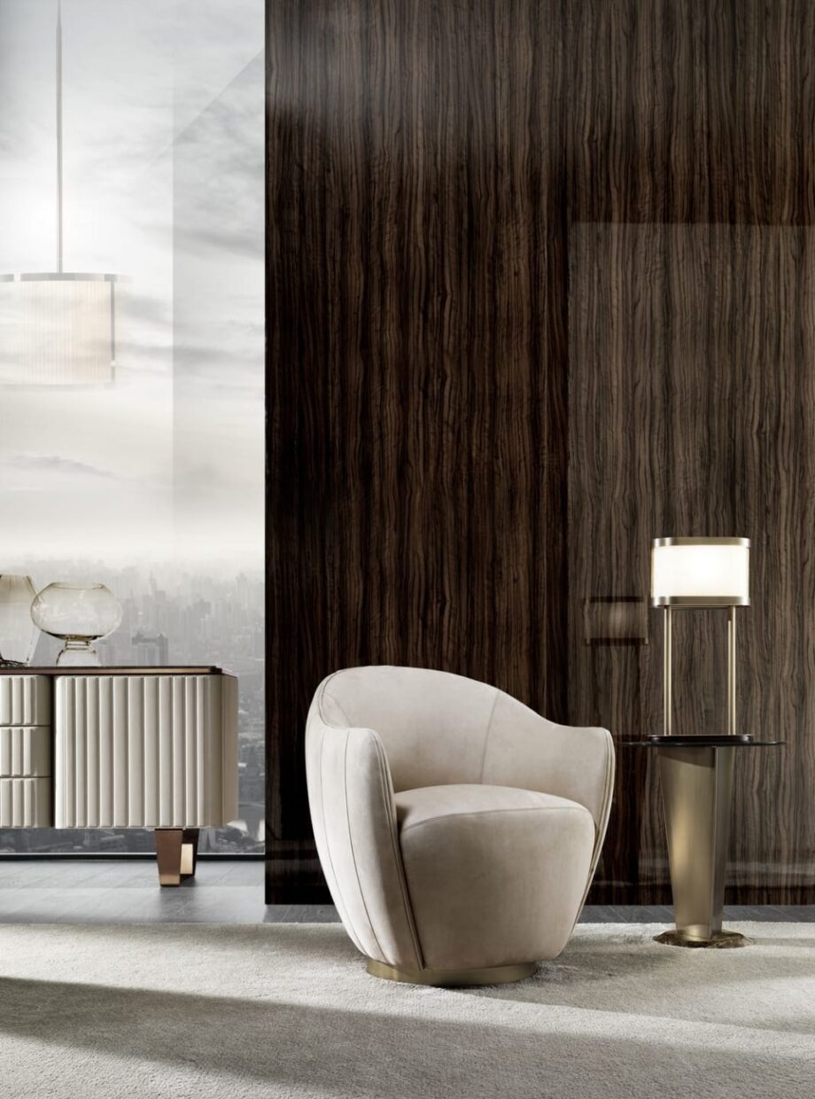 Hermes armchair | DV home. Luxurious Art Deco swivel armchair with a polished stainless steel base, offering supreme comfort and style.