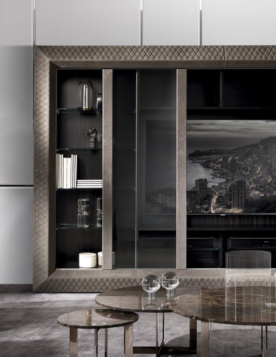 Byron Glass display cabinet | DV home. Elegant TV unit featuring Macassar ebony veneer, quilted leather, tempered glass sliding doors, and integrated lighting.