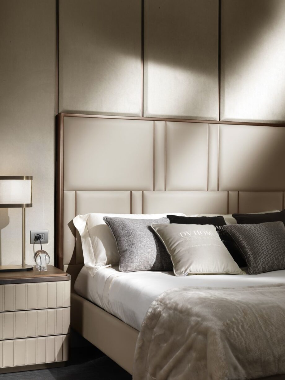 Elite bed | DV home. Elegant bed featuring a high tufted headboard and sophisticated metallic accents, creating an ambiance of luxury and comfort.