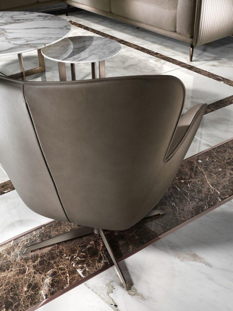 Elite armchair | DV home. Elegant swivel armchair with a chrome base, offering luxurious comfort and contemporary style.