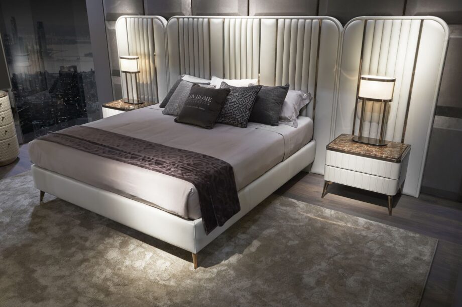 Hollywood Maxi bed | DV home. An opulent Italian luxury bed featuring a striking high upholstered headboard with elegant vertical inserts, perfect for sophisticated bedrooms.
