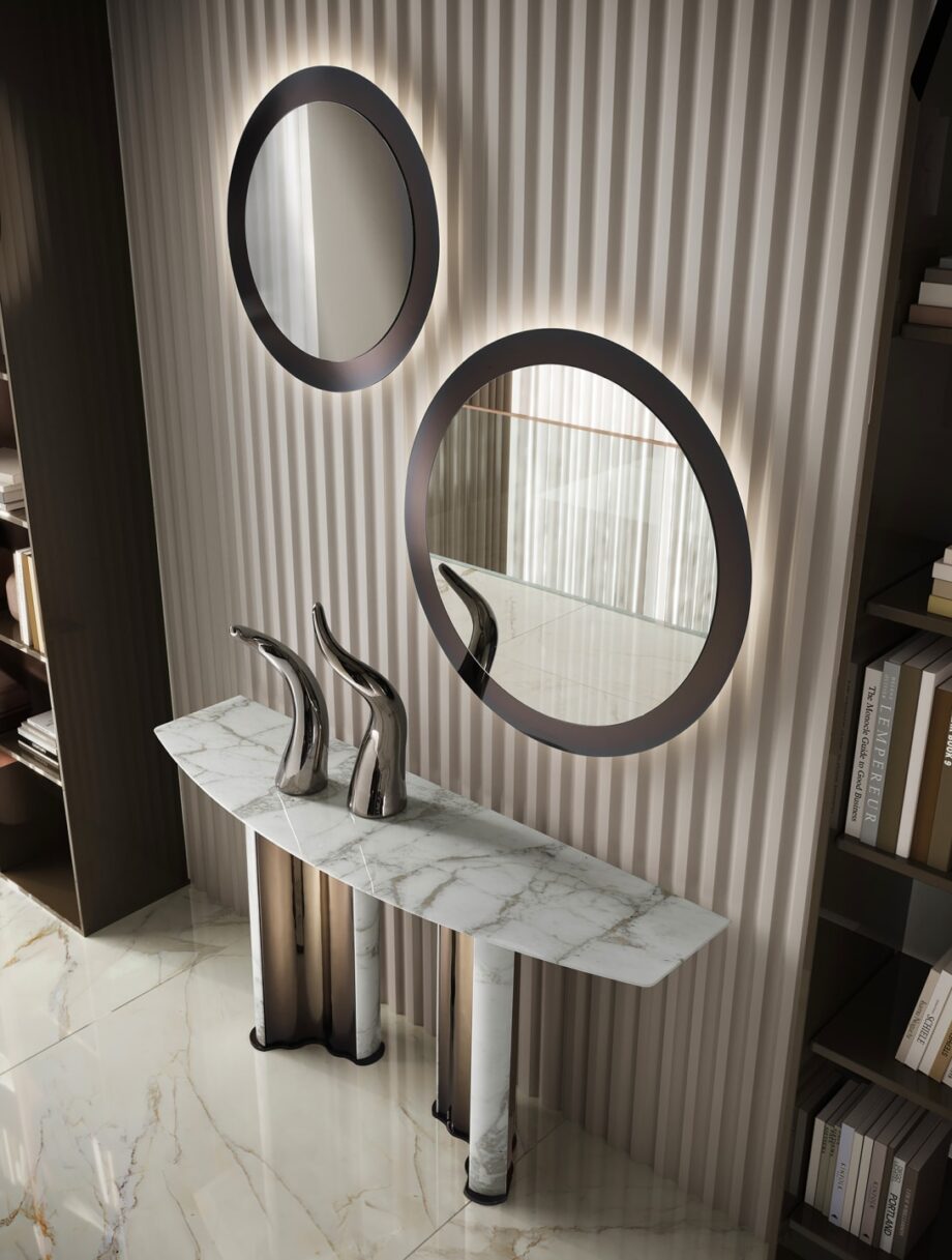 Envy Circle mirror | DV home. A luxurious round mirror with a polished stainless steel frame, perfect for adding an elegant Art Deco touch to any sophisticated interior.