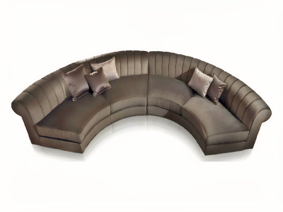 Kent Round sofa | DV home. Luxurious curved sectional sofa with goose feather cushions and chrome base, embodying Art Deco elegance.