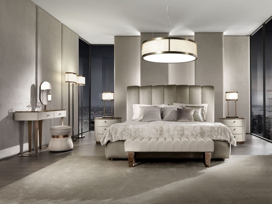 Byron bed | DV home. Luxurious upholstered bed with a high, vertically tufted headboard, offering bespoke comfort and Art Deco elegance.