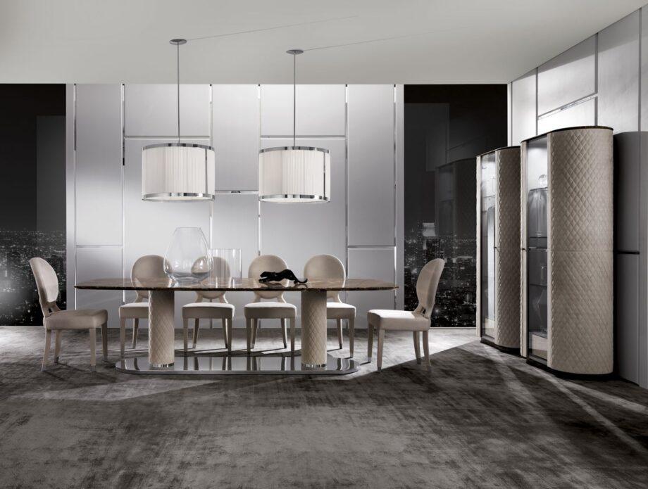 Adler table | DV home. Elegant dining table featuring a polished steel base, leather-clad columns, and a luxurious marble top.