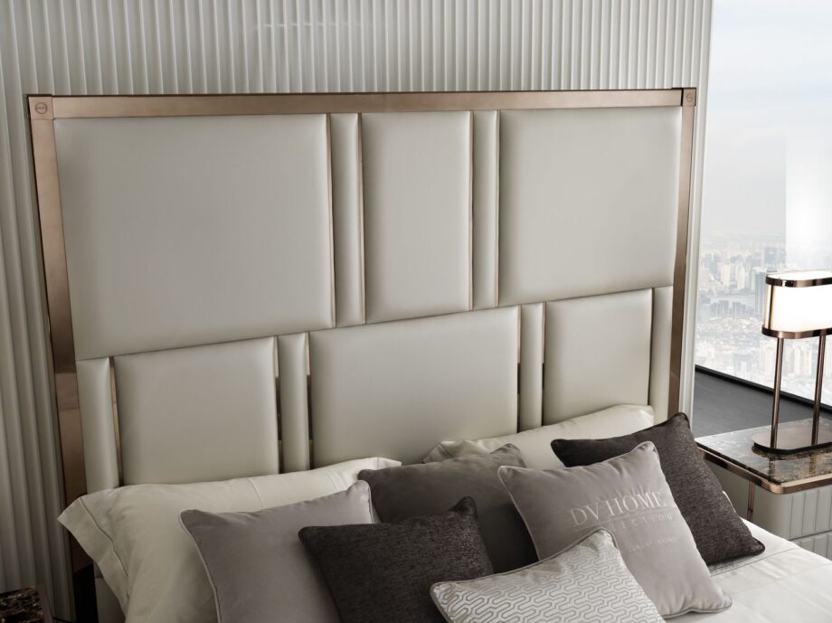 Elite bed | DV home. Elegant bed featuring a high tufted headboard and sophisticated metallic accents, creating an ambiance of luxury and comfort.