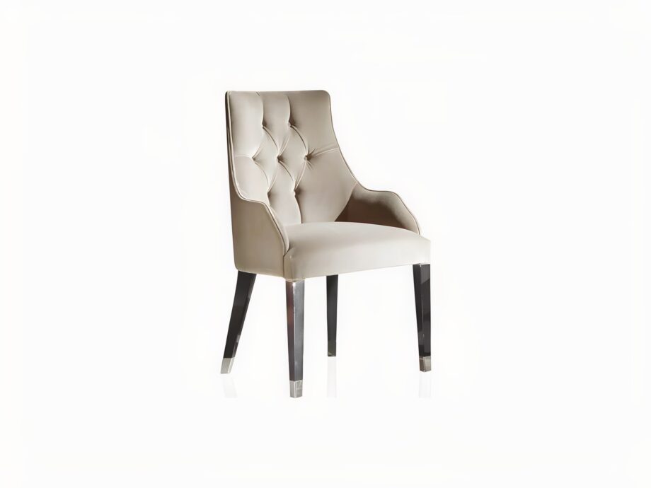 Byron Capitonné chair | DV home. Exquisite armchair featuring capitonné upholstery and polished steel feet, perfect for elegant interiors.