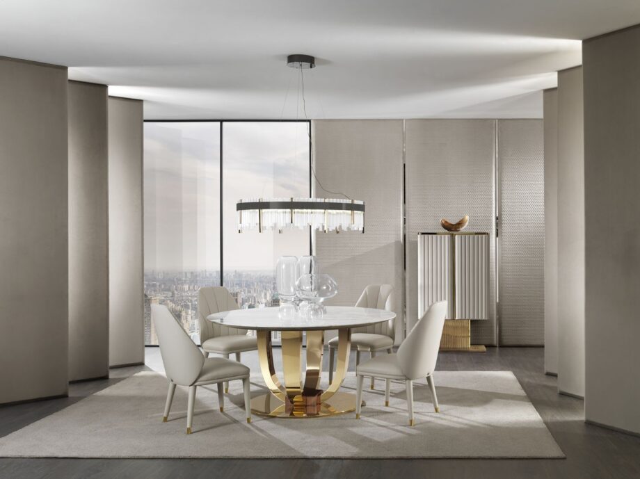 Hermes Round table | DV home. Exquisite Art Deco dining table with a luxurious marble top and a distinctive metal base, perfect for upscale interiors.