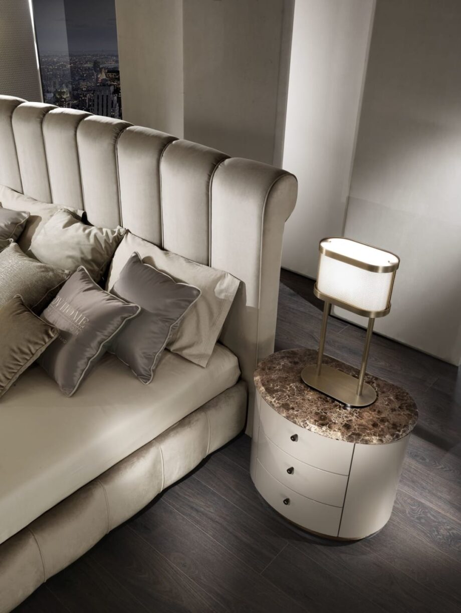 Byron bed | DV home. Luxurious upholstered bed with a high, vertically tufted headboard, offering bespoke comfort and Art Deco elegance.
