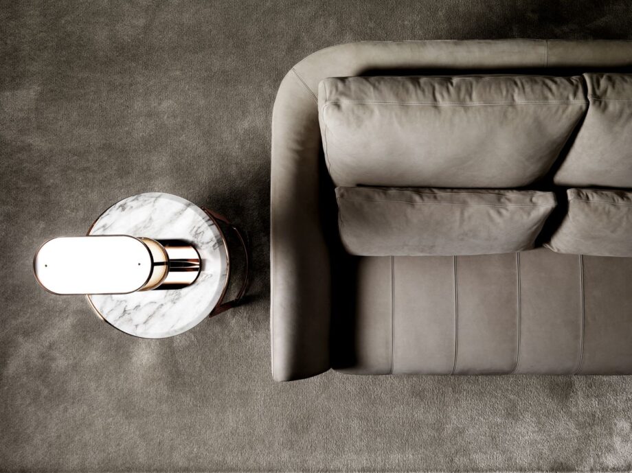 Ritz sofa | DV home. Luxurious custom upholstered sofa with elegant steel frame and plush goose feather cushions, epitomizing Art Deco sophistication.