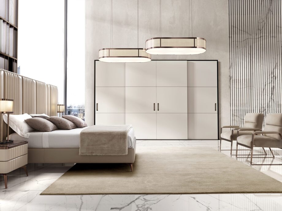 Hollywood Maxi bed | DV home. An opulent Italian luxury bed featuring a striking high upholstered headboard with elegant vertical inserts, perfect for sophisticated bedrooms.
