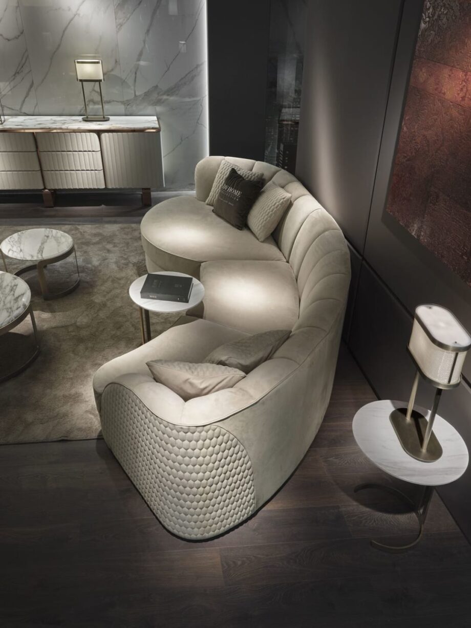 Charlotte Island sofa | DV home. A luxurious, handcrafted sectional sofa with a curved design, perfect for sophisticated living spaces.