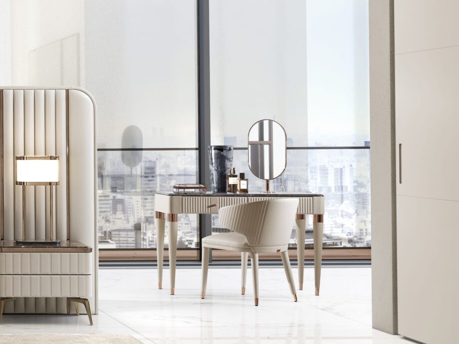 Hollywood chair | DV home. Elegant armchair with curved lines and quilted back, embodying luxury and comfort in contemporary Art Deco style.