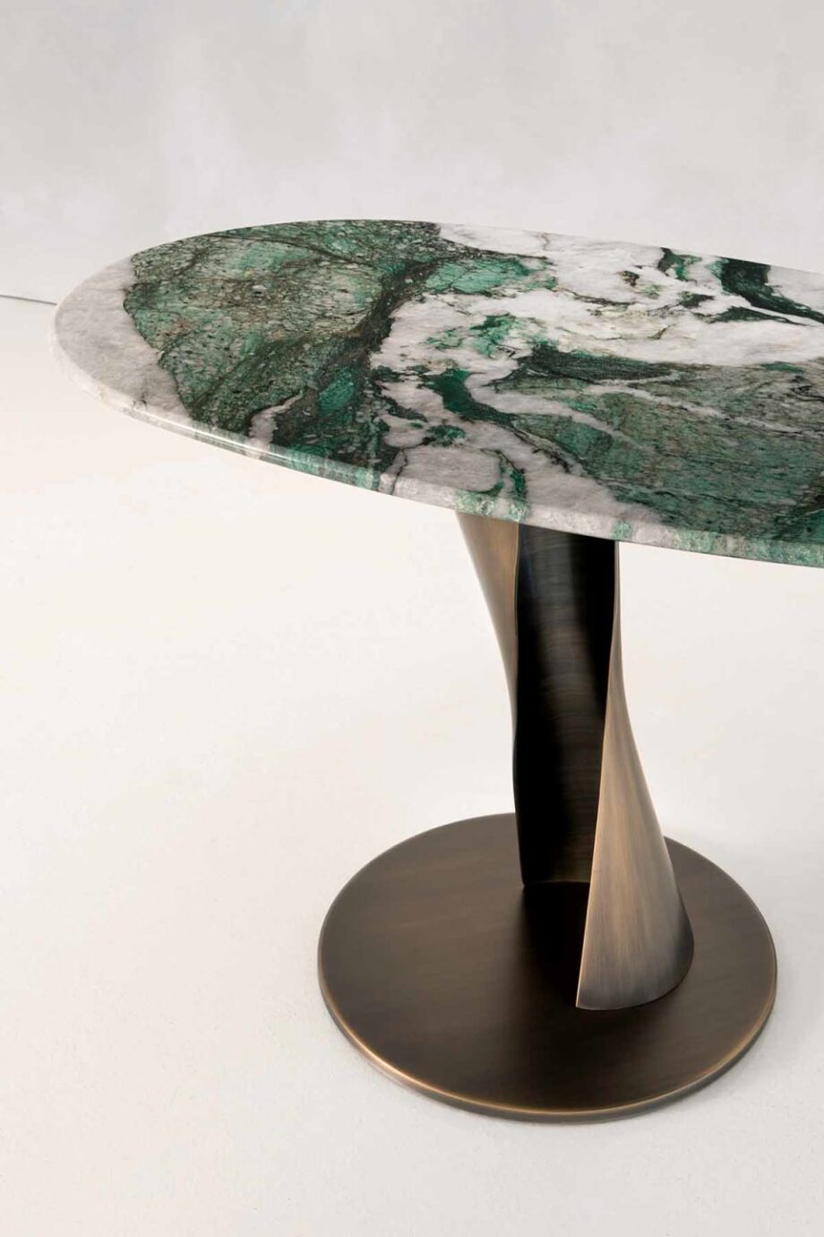 Zoe coffee table | Rugiano. Sculptural coffee table with a bronze fusion base and top in wood, marble, or leather.