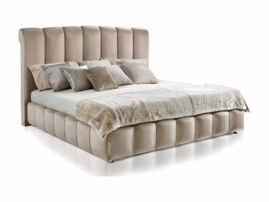 Byron bed | DV home. Luxurious upholstered bed with a high, vertically tufted headboard, offering bespoke comfort and Art Deco elegance.