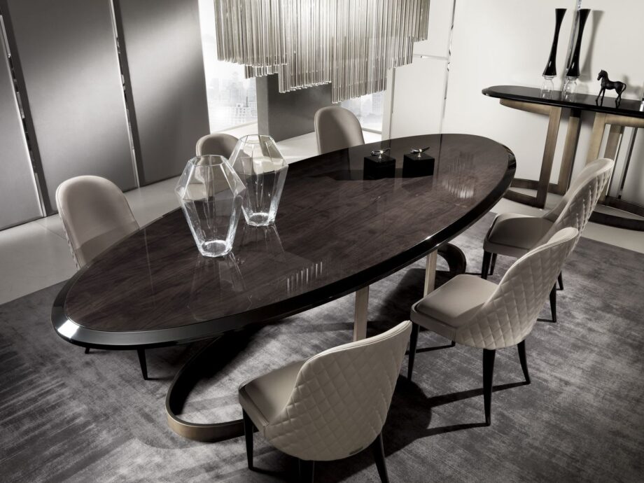 Form Prince table | DV home. An exquisite Art Deco dining table with a curved stainless steel base and luxurious lacquered or wood veneer top.