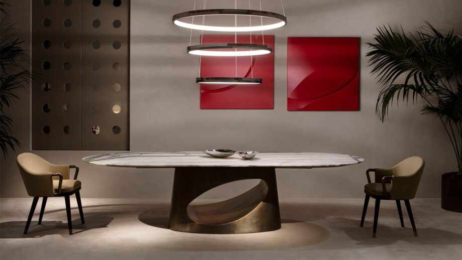 Ring table | Rugiano. Exquisite table with an oval marble top and a unique sculptural bronze base.