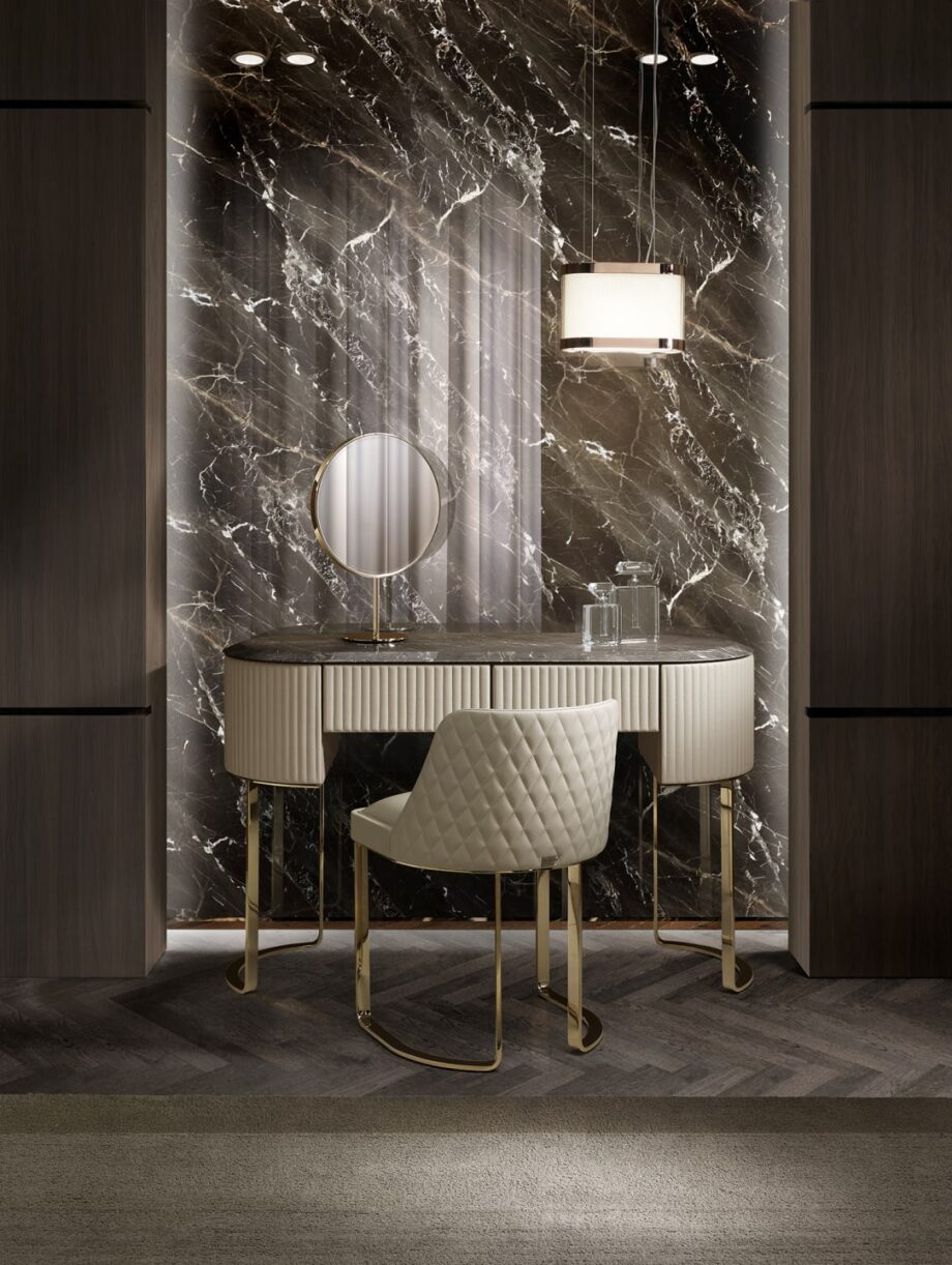 Coco chair | DV home. Elegant Art Deco chair with a chrome base and quilted armrests, perfect for luxurious interiors.