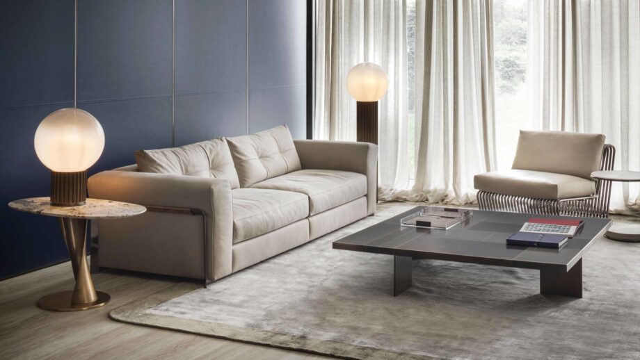 Zoe coffee table | Rugiano. Sculptural coffee table with a bronze fusion base and top in wood, marble, or leather.