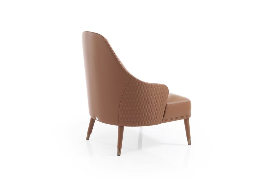 Manhattan armchair | DV home. Luxurious Art Deco armchair with quilted back, covered legs, and shining steel feet, offering sophisticated comfort.