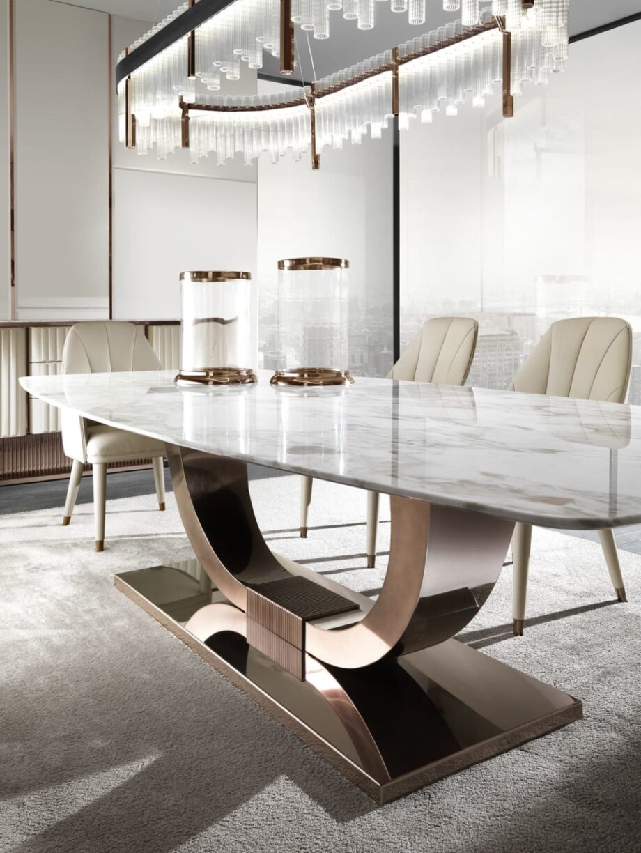 Heritage table | DV home. Luxurious dining table with bold Art Deco design, stainless steel base, and exquisite top options.