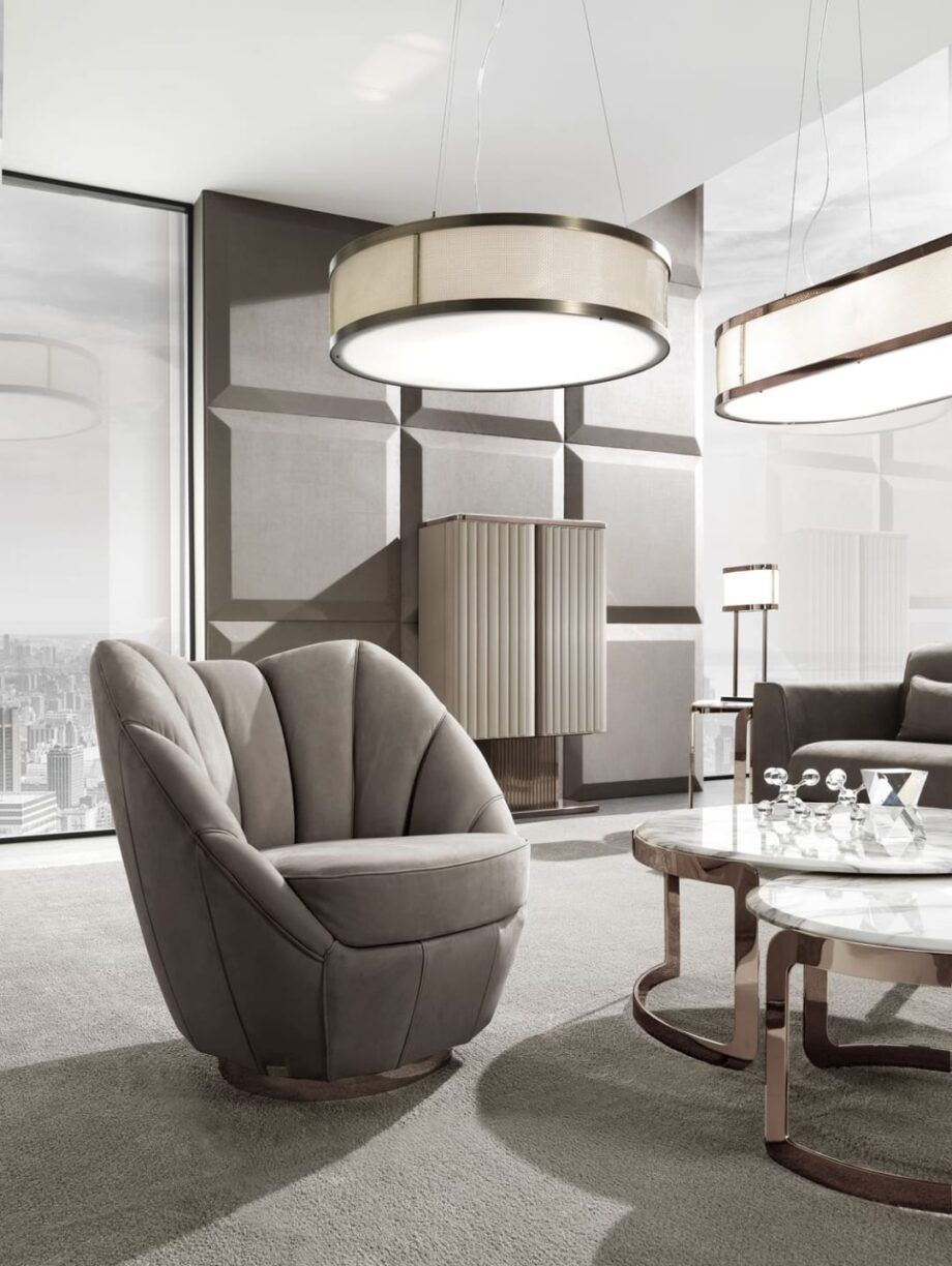 Royal armchair | DV home. Elegant swivel armchair with premium upholstery and a polished stainless steel base.