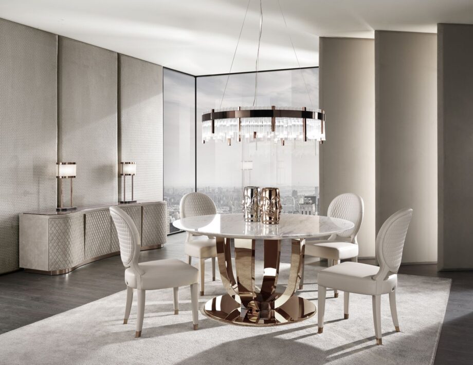 Hermes Round table | DV home. Exquisite Art Deco dining table with a luxurious marble top and a distinctive metal base, perfect for upscale interiors.