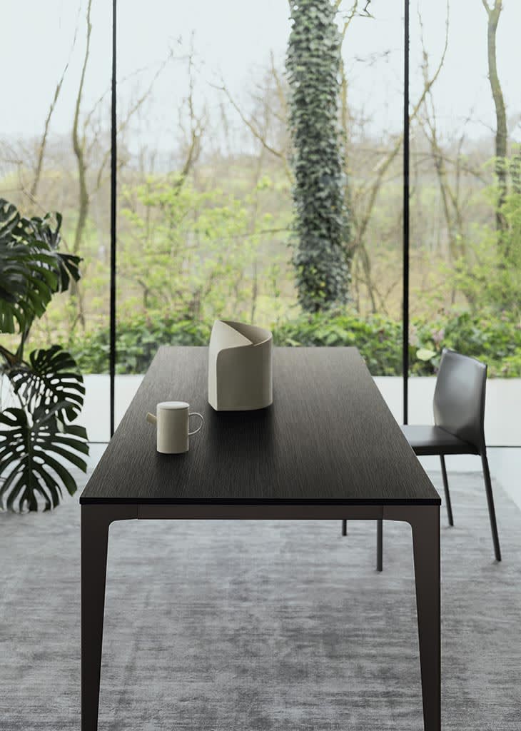 Jag table | ALF Dafre. Elegant, extendable table featuring a metal base and a wood or ceramic top.