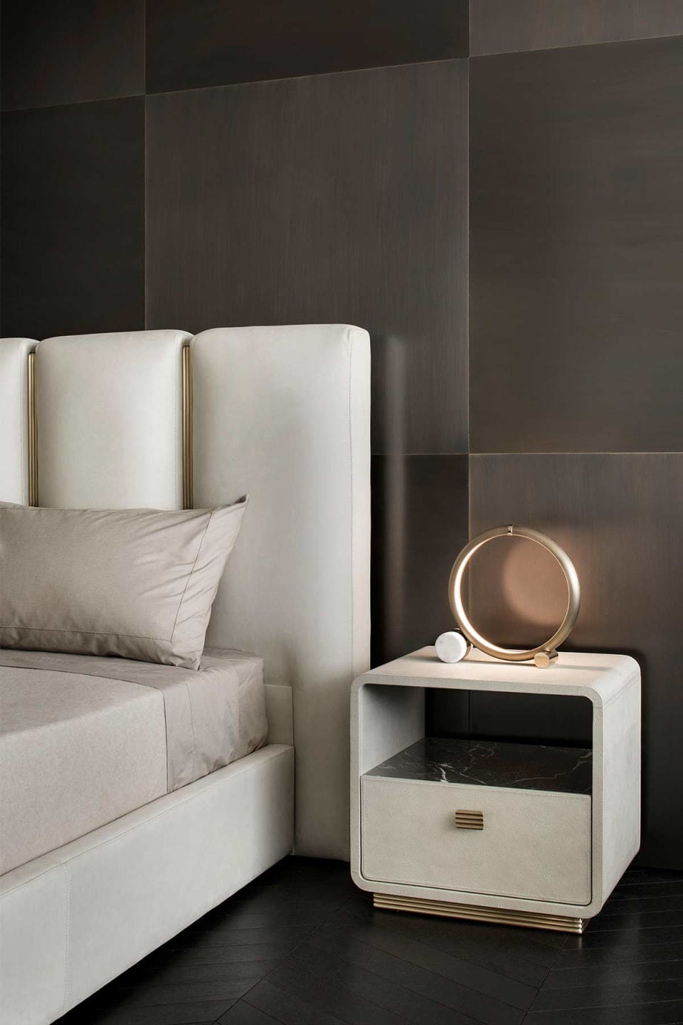 Club bed | Rugiano. Luxurious bed with upholstered headboard featuring brushed metal and leather details, creating a sophisticated aesthetic.