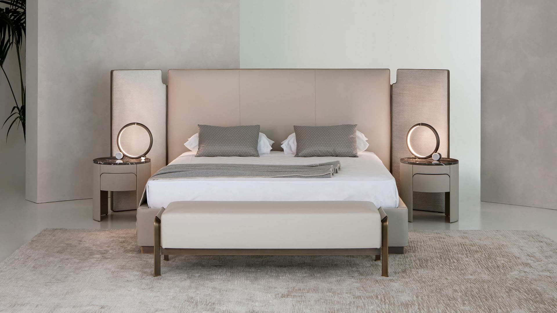 Falcon bed | Rugiano. Sculptural bed with integrated side wings and refined bronze detail, offering customizable luxury and deep comfort.