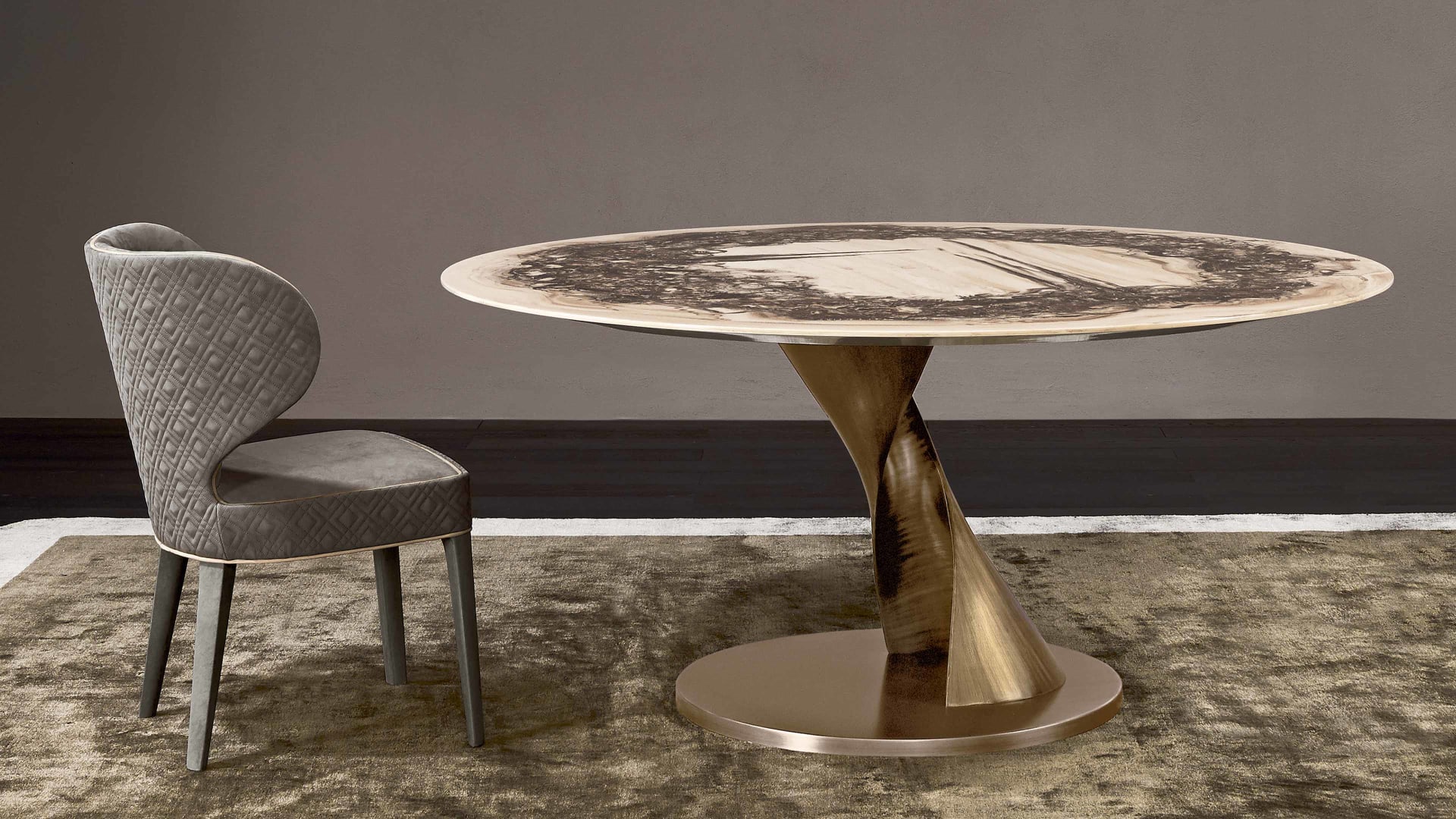 Zoe table | Rugiano. Elegant, sculptural dining table with a bronze base and customizable top options.