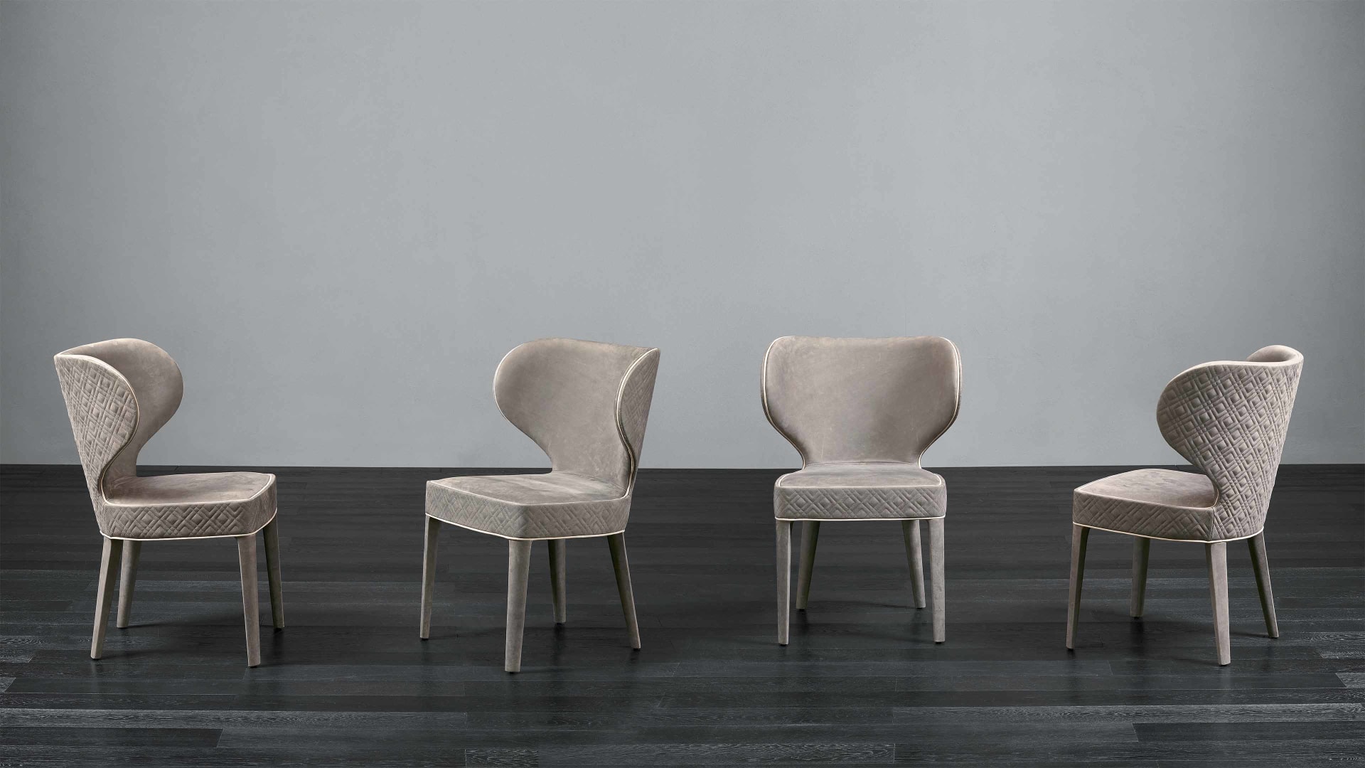 Aida armchair | Rugiano. An exquisitely designed upholstered chair with an optional high back and elegant wooden legs, offering versatile comfort.
