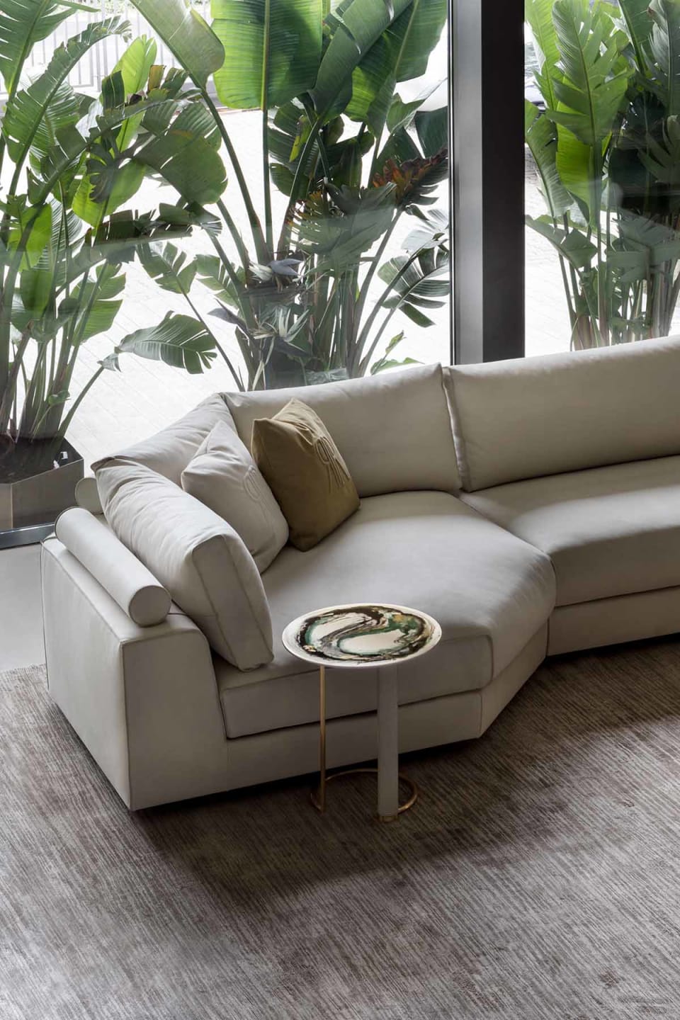 Nautilus sofa | Rugiano. Modular sofa system with integrated bookshelves, shelves, and side tables, featuring distinctive raw-cut leather details.