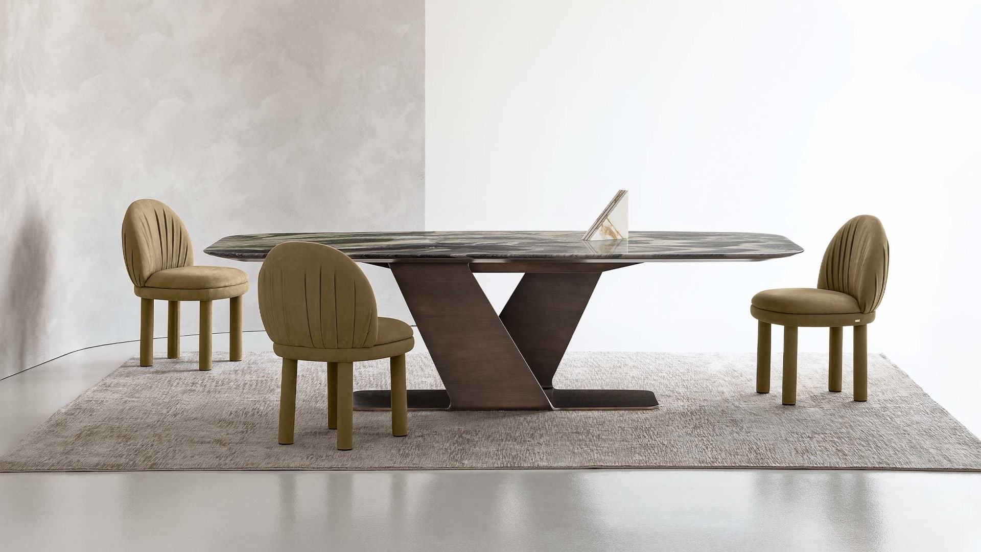 Wally table | Rugiano. A masterpiece of design, featuring a sculptural base and exquisite natural stone top, enhanced by distinctive decoration.