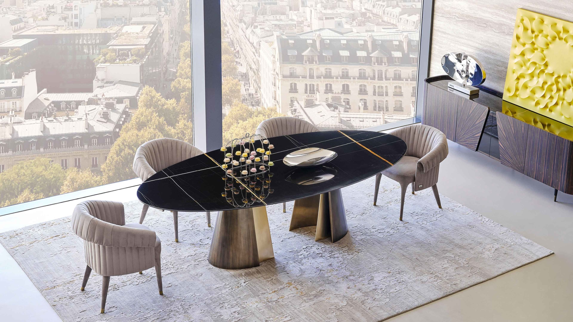 Absolute table | Rugiano. A luxurious dining table featuring a sculptural metal base with contrasting finishes and versatile top options.