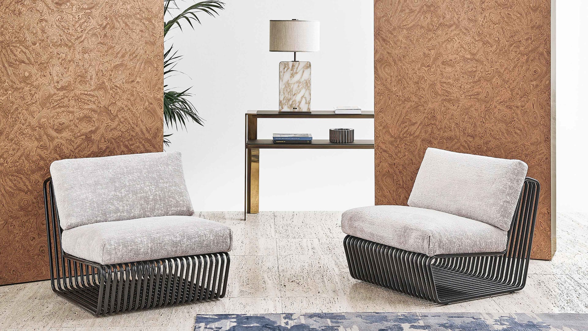 Infinity armchair | Rugiano. A sculptural piece with a sinuous shape and luxurious metal accents, offering unparalleled style and comfort.