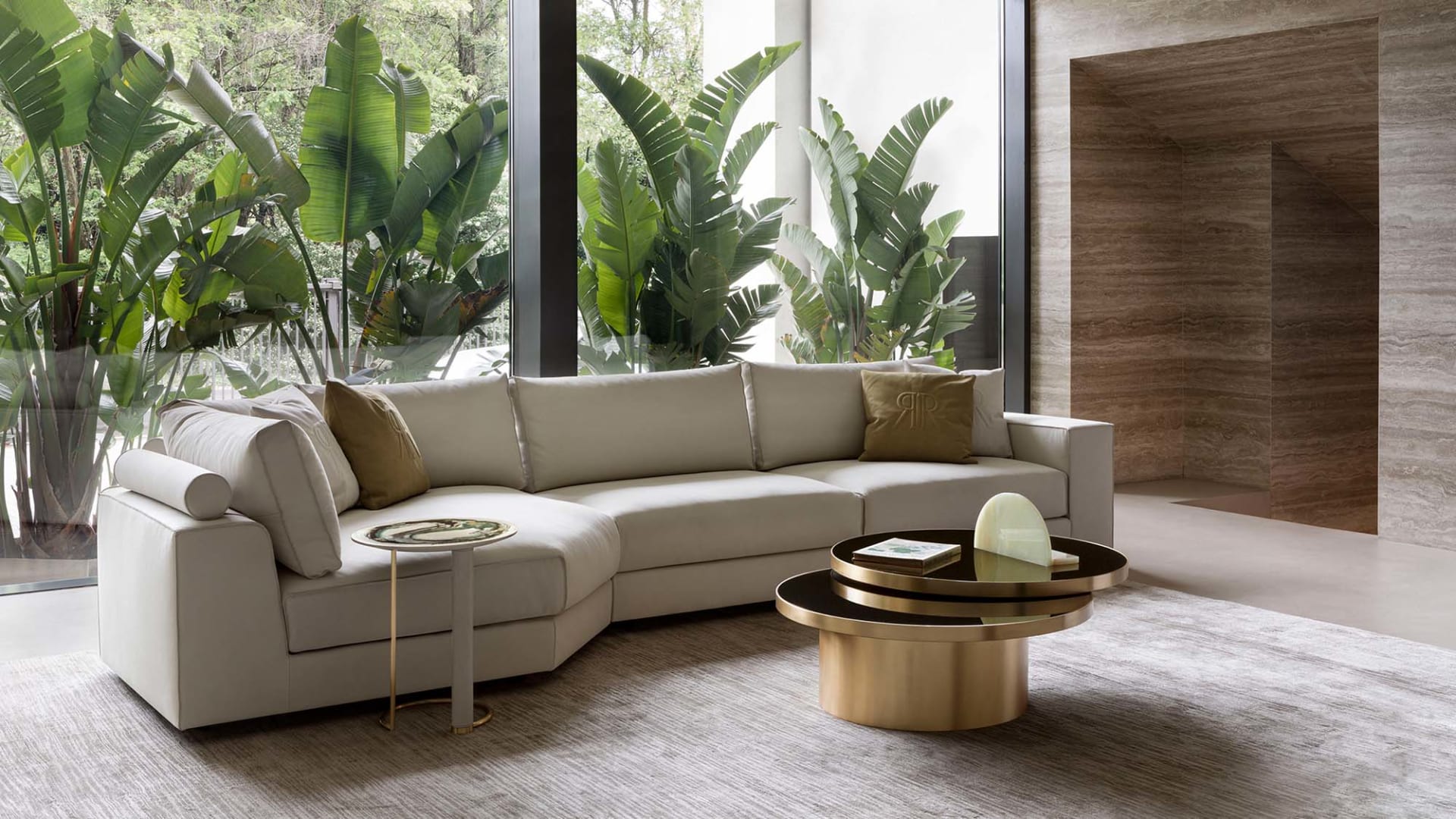 Nautilus sofa | Rugiano. Modular sofa system with integrated bookshelves, shelves, and side tables, featuring distinctive raw-cut leather details.