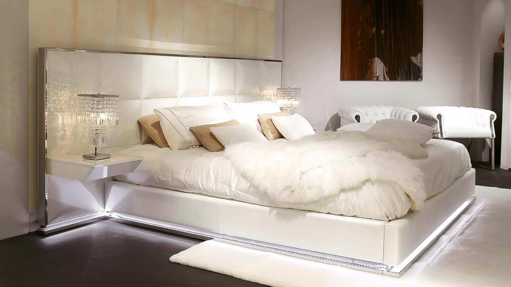 Gemma bed | Rugiano. Elegant bed featuring a high tufted headboard and optional integrated nightstands, creating a luxurious bedroom ambiance.