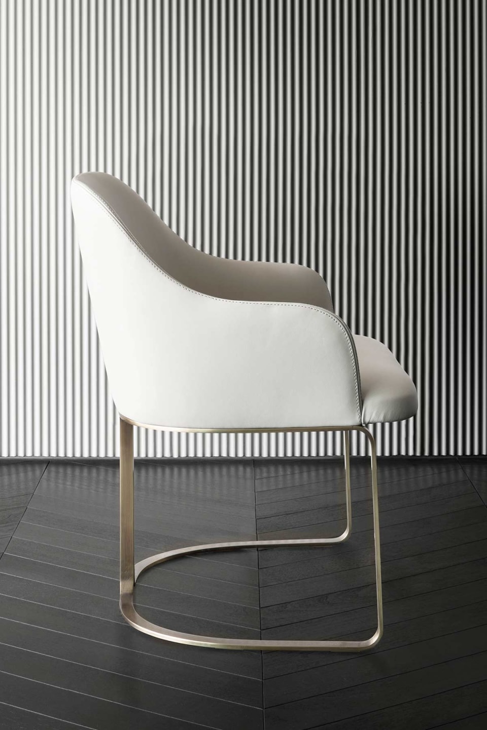 Marie chair | Rugiano. Upholstered chair with a sleek silhouette and elegant bronze base, perfect for modern interiors.