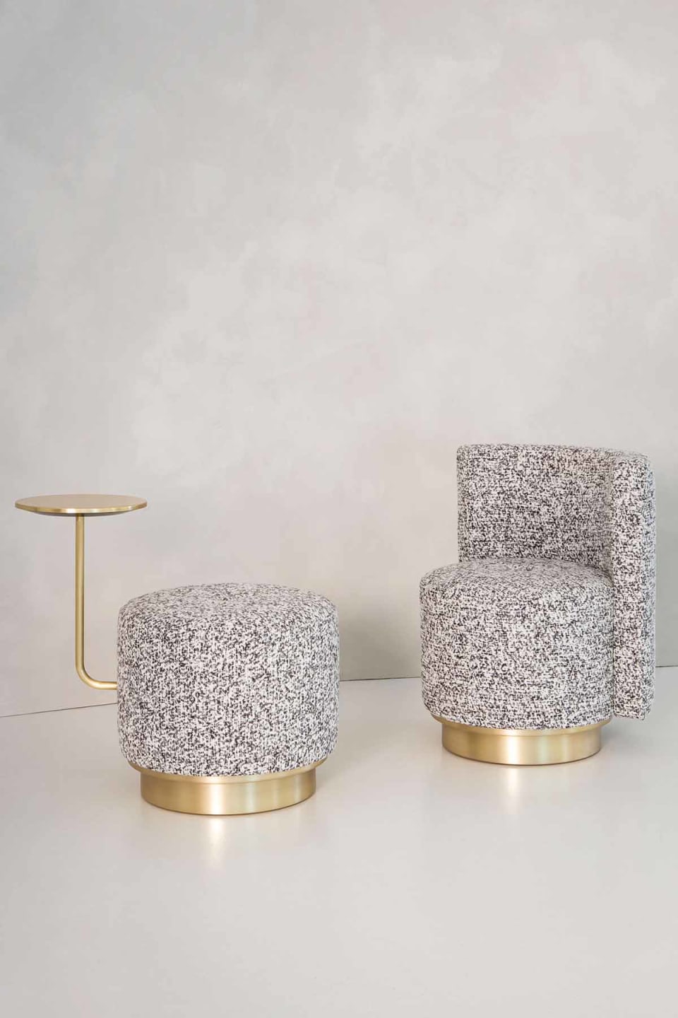 Harry pouf | Rugiano. Versatile upholstered poufs with elegant satin gold details, available in classic, armrest, and integrated side table designs.