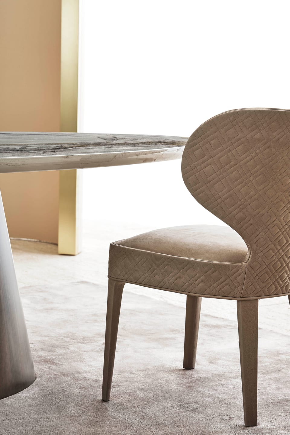 Aida armchair | Rugiano. An exquisitely designed upholstered chair with an optional high back and elegant wooden legs, offering versatile comfort.