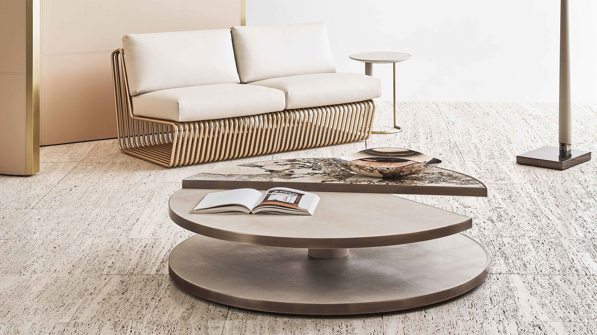 Moon coffee table | Rugiano. A luxurious round coffee table featuring exquisite marble and leather or ebony tops, complemented by elegant bronze profiles.