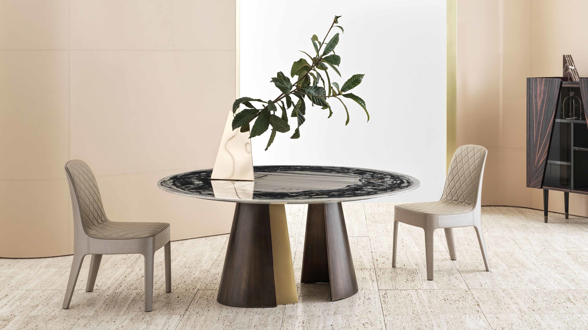 Absolute Round table | Rugiano. A striking dining table with a sculpturesque base, featuring contrasting metal finishes and a choice of exquisite wood or marble tops.