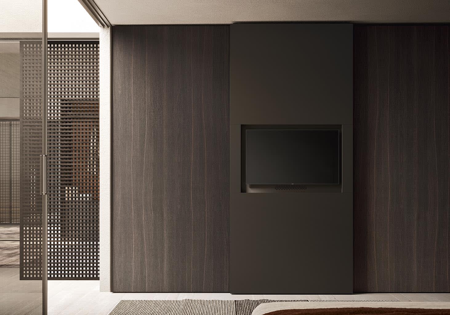 Television Sliding Door wardrobe | ALF Dafre. Elegant bedroom unit with sliding doors, discreetly housing a TV for a seamless modern interior.
